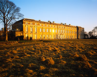 Low winter sun is reflected from the windows of Petworth House